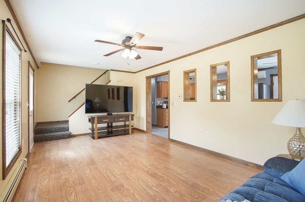 113 Batchelor Street Granby, MA 01033 - Photo 14 of 37 a living room with furniture and a flat screen tv