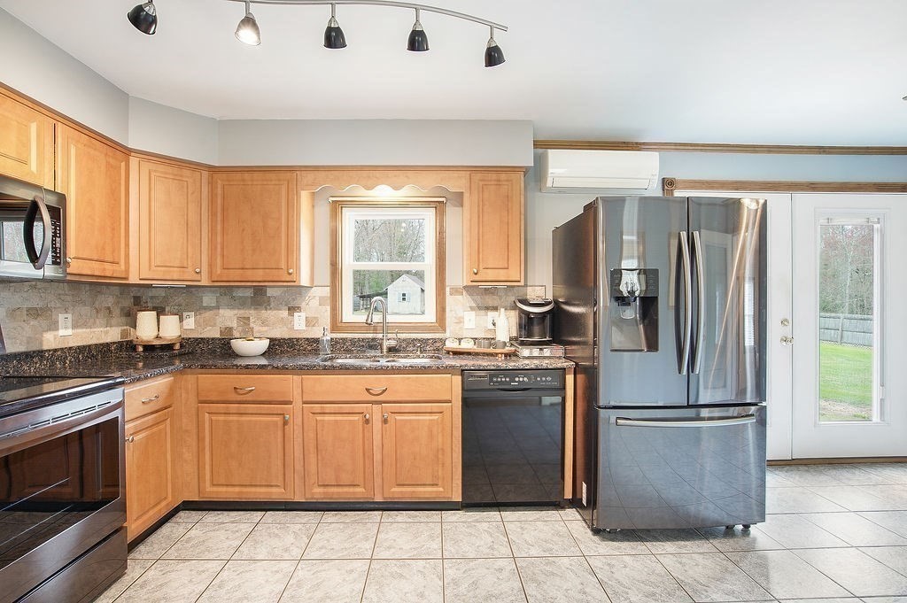 113 Batchelor Street Granby, MA 01033 - Photo 7 of 37 a kitchen with stainless steel appliances granite countertop a refrigerator sink and stove