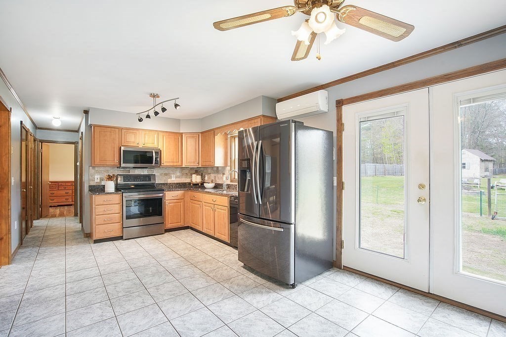 113 Batchelor Street Granby, MA 01033 - Photo 8 of 37 a kitchen with stainless steel appliances granite countertop a refrigerator and a sink