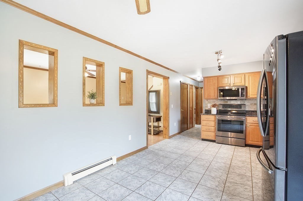 113 Batchelor Street Granby, MA 01033 - Photo 9 of 37 a kitchen with stainless steel appliances a refrigerator and a stove top oven
