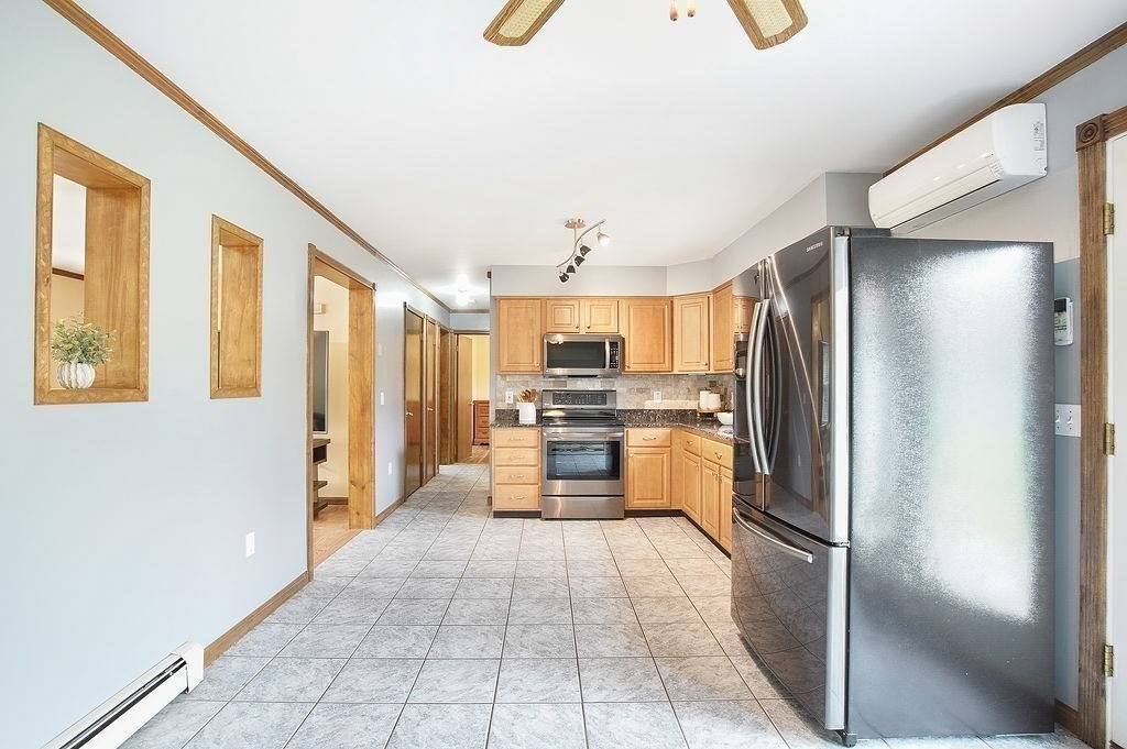 113 Batchelor Street Granby, MA 01033 - Photo 10 of 37 a large white kitchen with cabinets and stainless steel appliances