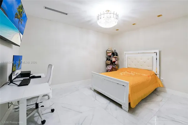 a bedroom with a bed and a table in it