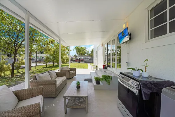 a backyard of a house with table and chairs