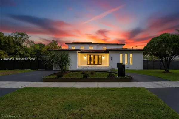 a front view of a house with a garden