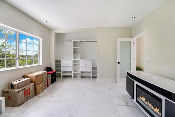 a kitchen with white cabinets and sink