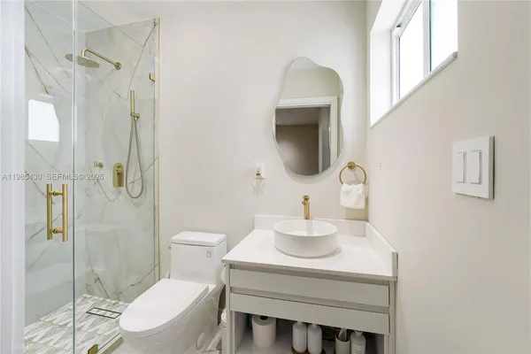a bathroom with a sink toilet and shower