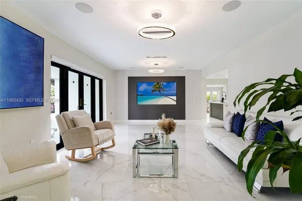 a living room with furniture and a large window