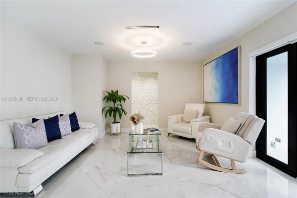 a living room with furniture and a potted plant