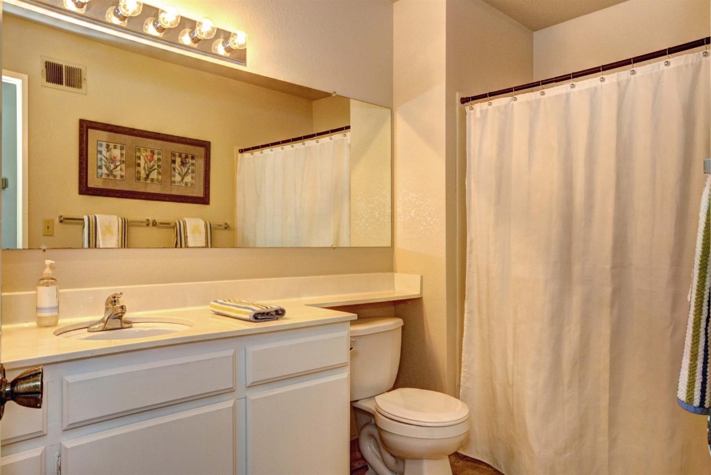2708 Glen Ferguson Circle San Jose, CA 95148 - Photo 19 of 23 a bathroom with a granite countertop sink and a mirror