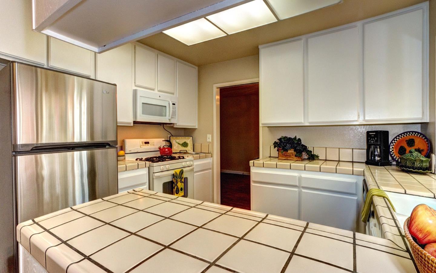 2708 Glen Ferguson Circle San Jose, CA 95148 - Photo 5 of 23 a kitchen with a stove a sink and a refrigerator