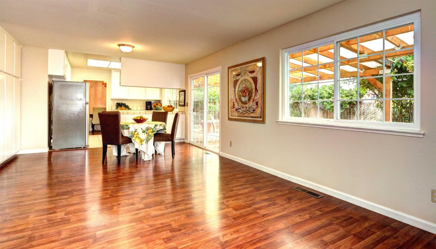 2708 Glen Ferguson Circle San Jose, CA 95148 - Photo 10 of 23 a view of a dining room with furniture floor to ceiling window and wooden floor