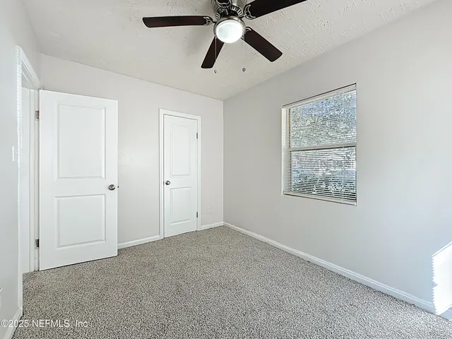 a view of a bathroom with a toilet and a shower