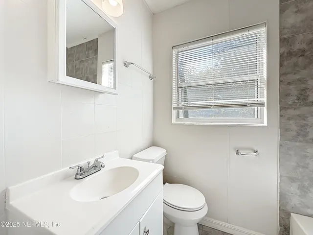 a bathroom with a toilet and a bathtub