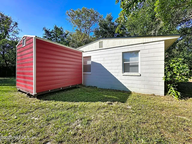 an aerial view of a house with a yard