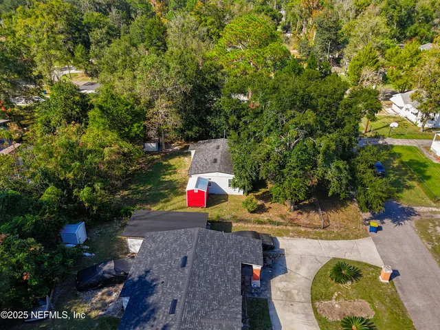 an aerial view of a houses with a yard