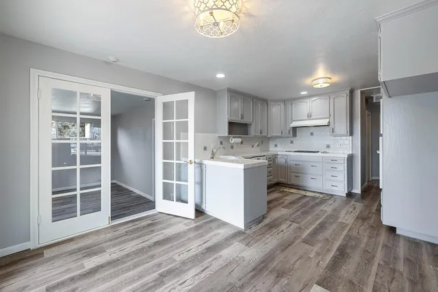 a kitchen with a refrigerator a sink and cabinets