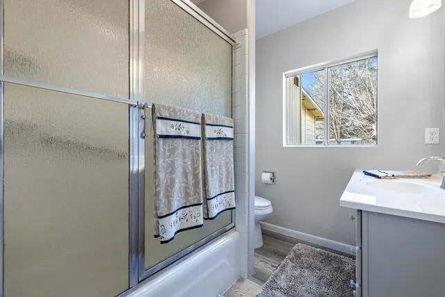 a bathroom with a shower sink and toilet
