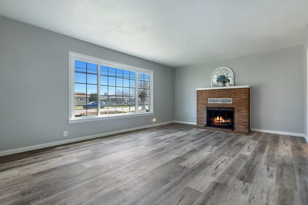 a view of a room with wooden floor and window