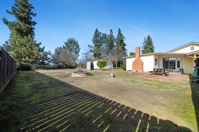 a view of a white house with a yard