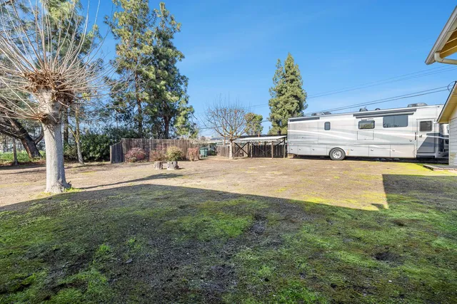 a view of a yard with an house and large trees