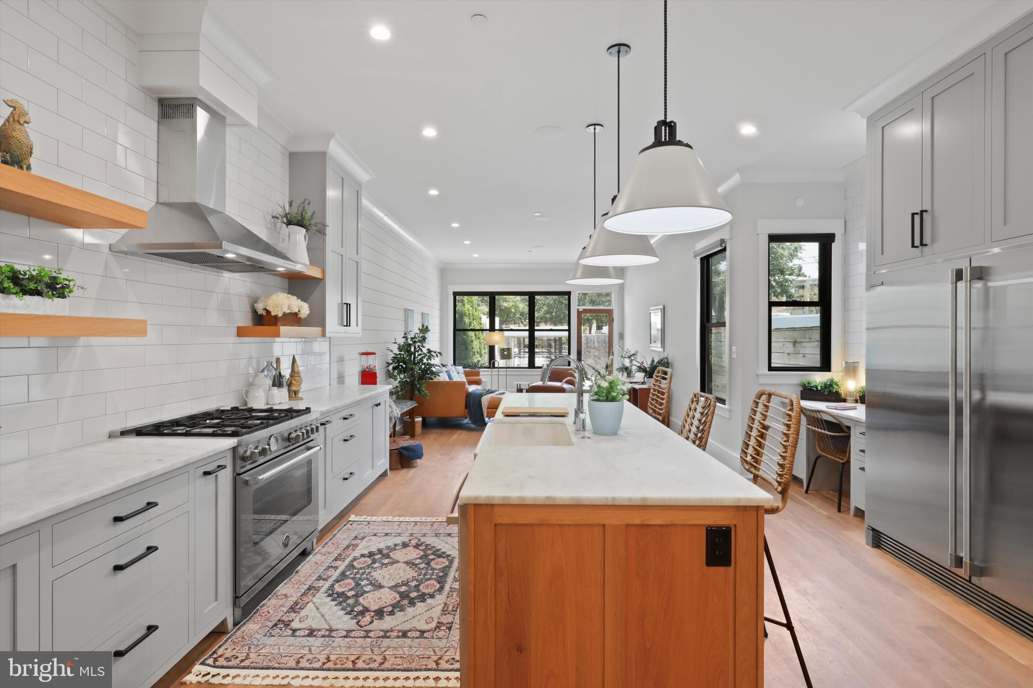 1432 G Street Southeast Washington, DC 20003 - Photo 13 of 56 a kitchen with stainless steel appliances granite countertop a sink stove and refrigerator