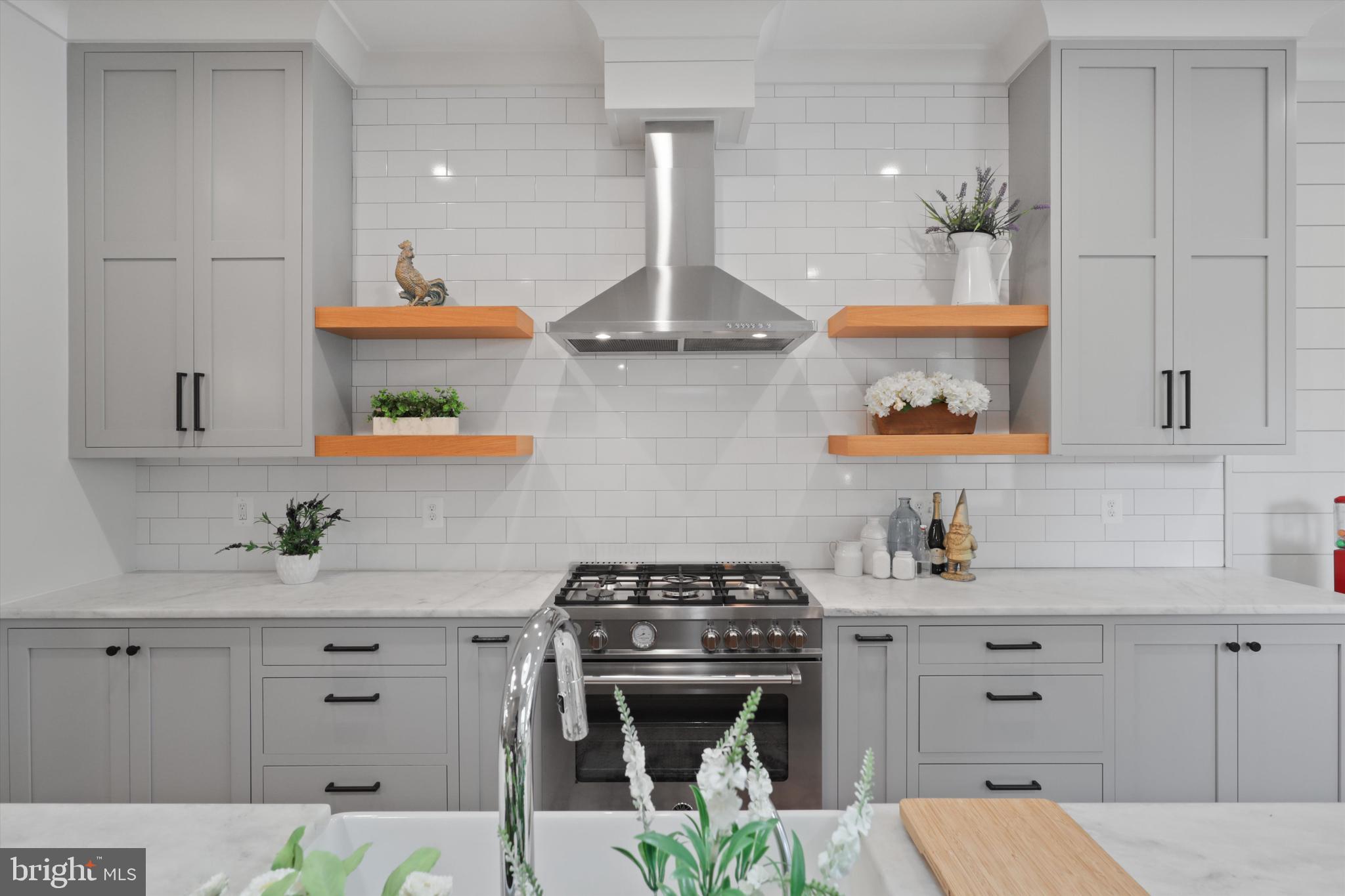 1432 G Street Southeast Washington, DC 20003 - Photo 14 of 56 a kitchen with stainless steel appliances a stove a sink and cabinets