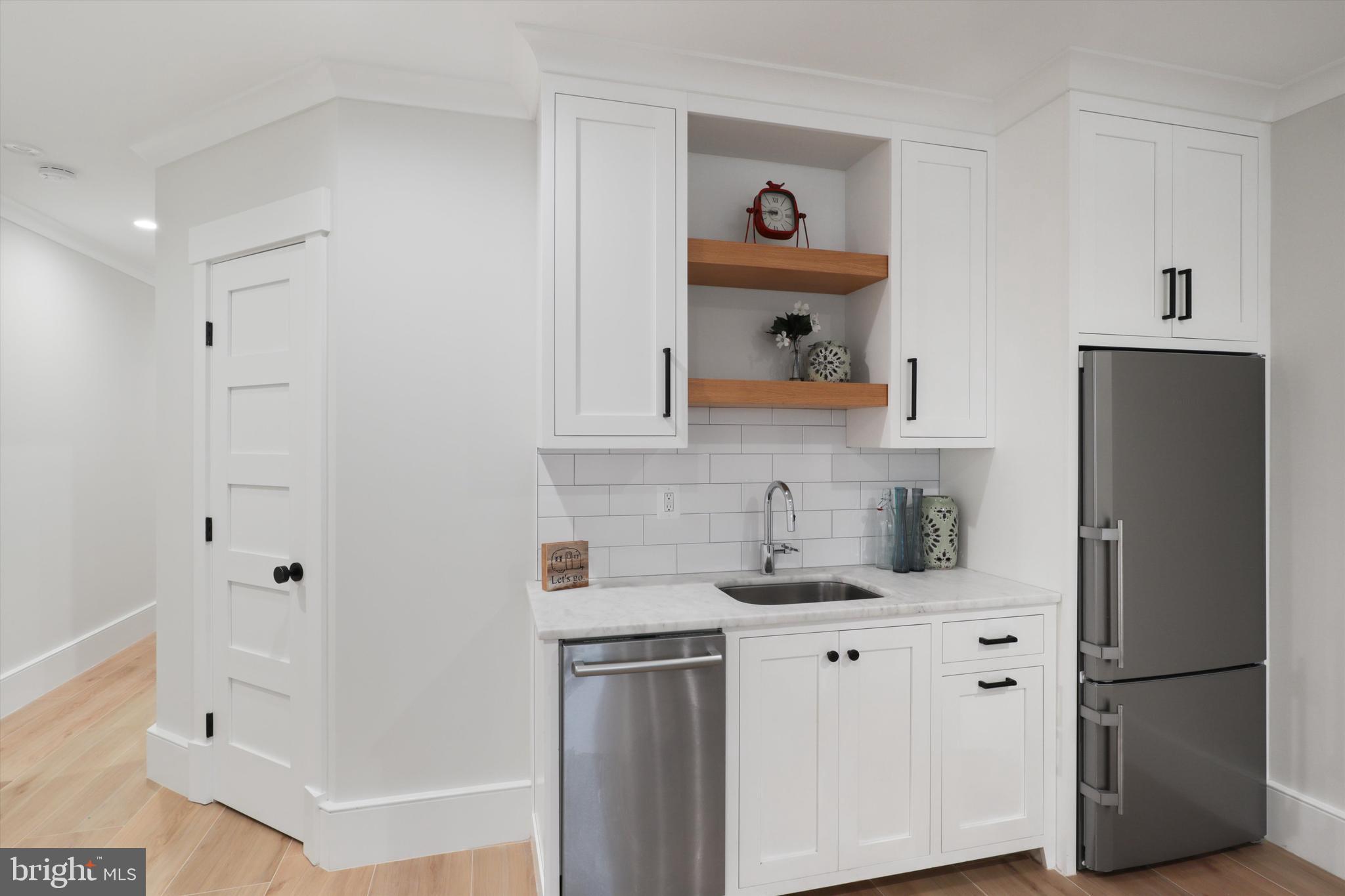 1432 G Street Southeast Washington, DC 20003 - Photo 40 of 56 a kitchen with cabinets and a refrigerator