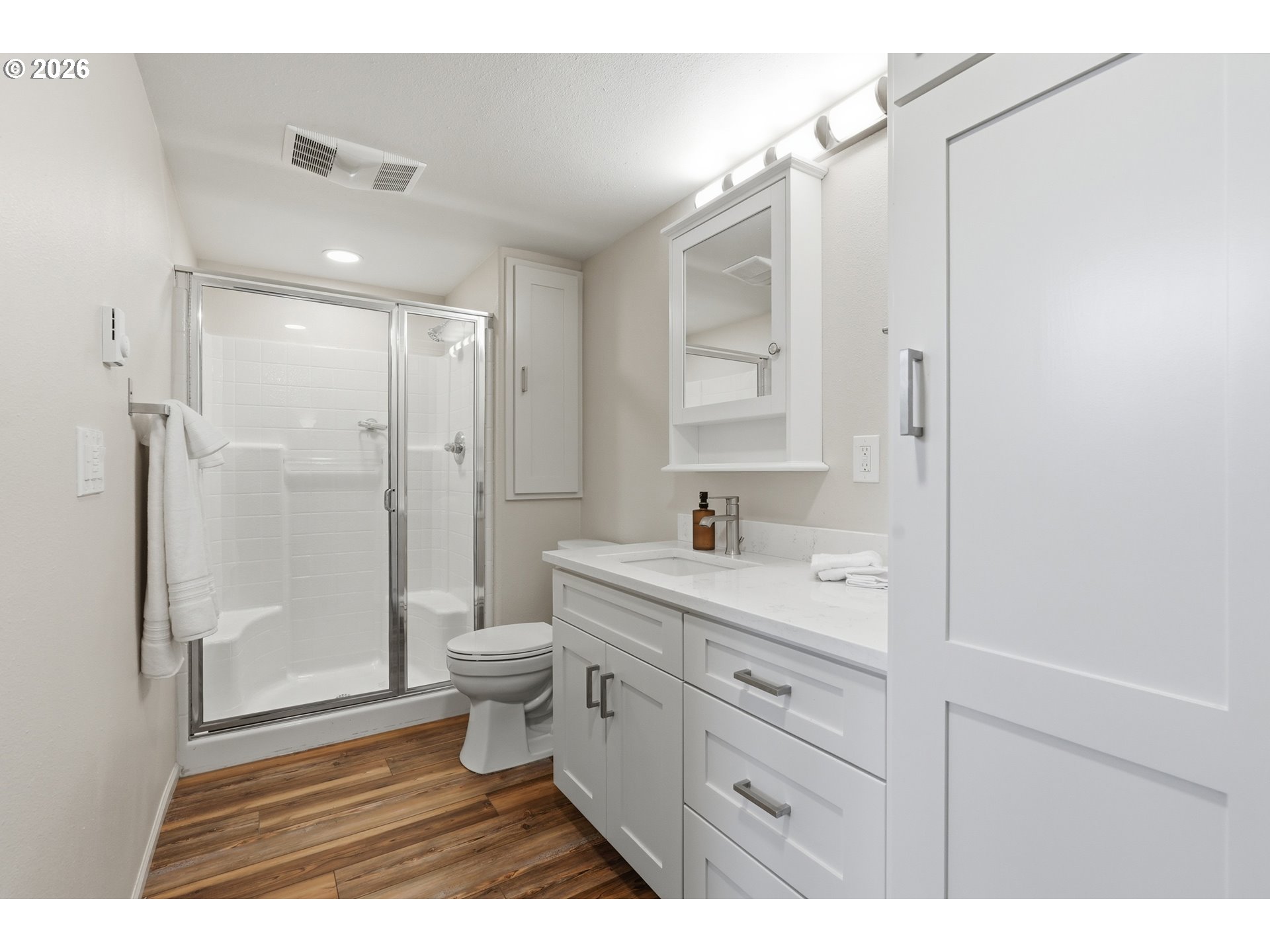 14885 Southwest Osprey Court Beaverton, OR 97007 - Photo 15 of 31 a bathroom with a double vanity sink toilet mirror and shower