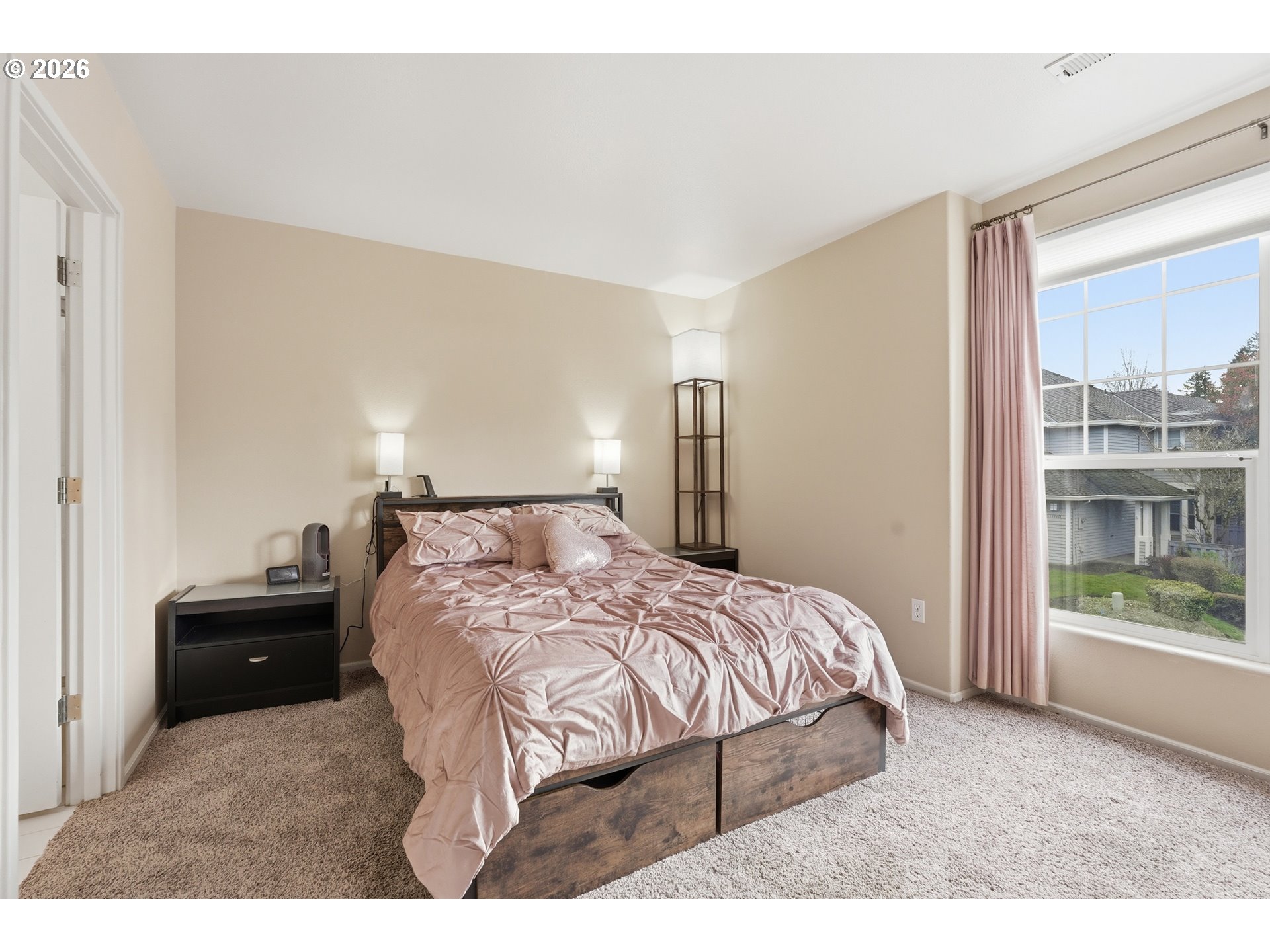 14885 Southwest Osprey Court Beaverton, OR 97007 - Photo 21 of 31 a bedroom with a bed window and a night stand