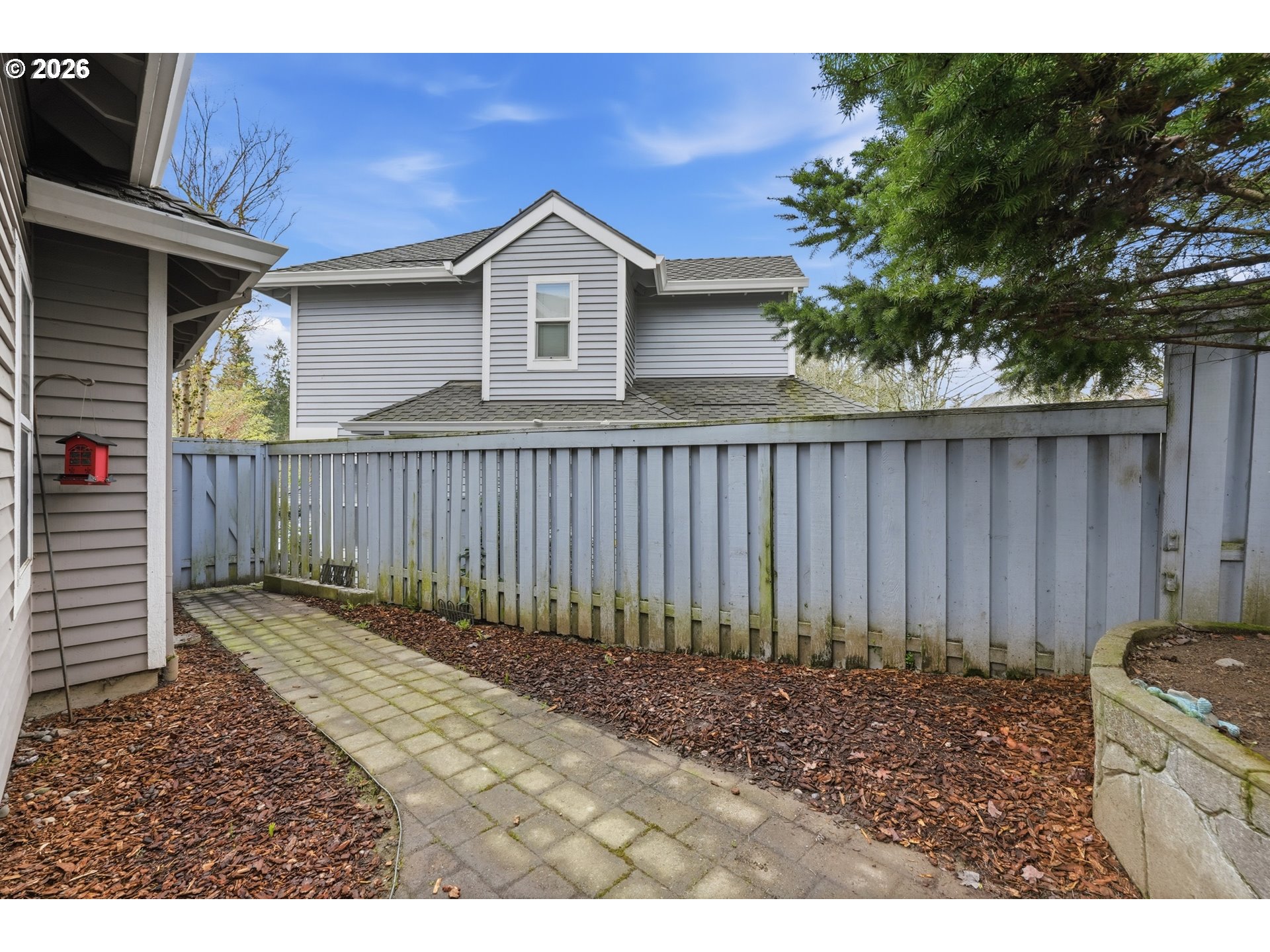 14885 Southwest Osprey Court Beaverton, OR 97007 - Photo 31 of 31 a view of a backyard with a trees and wooden fence