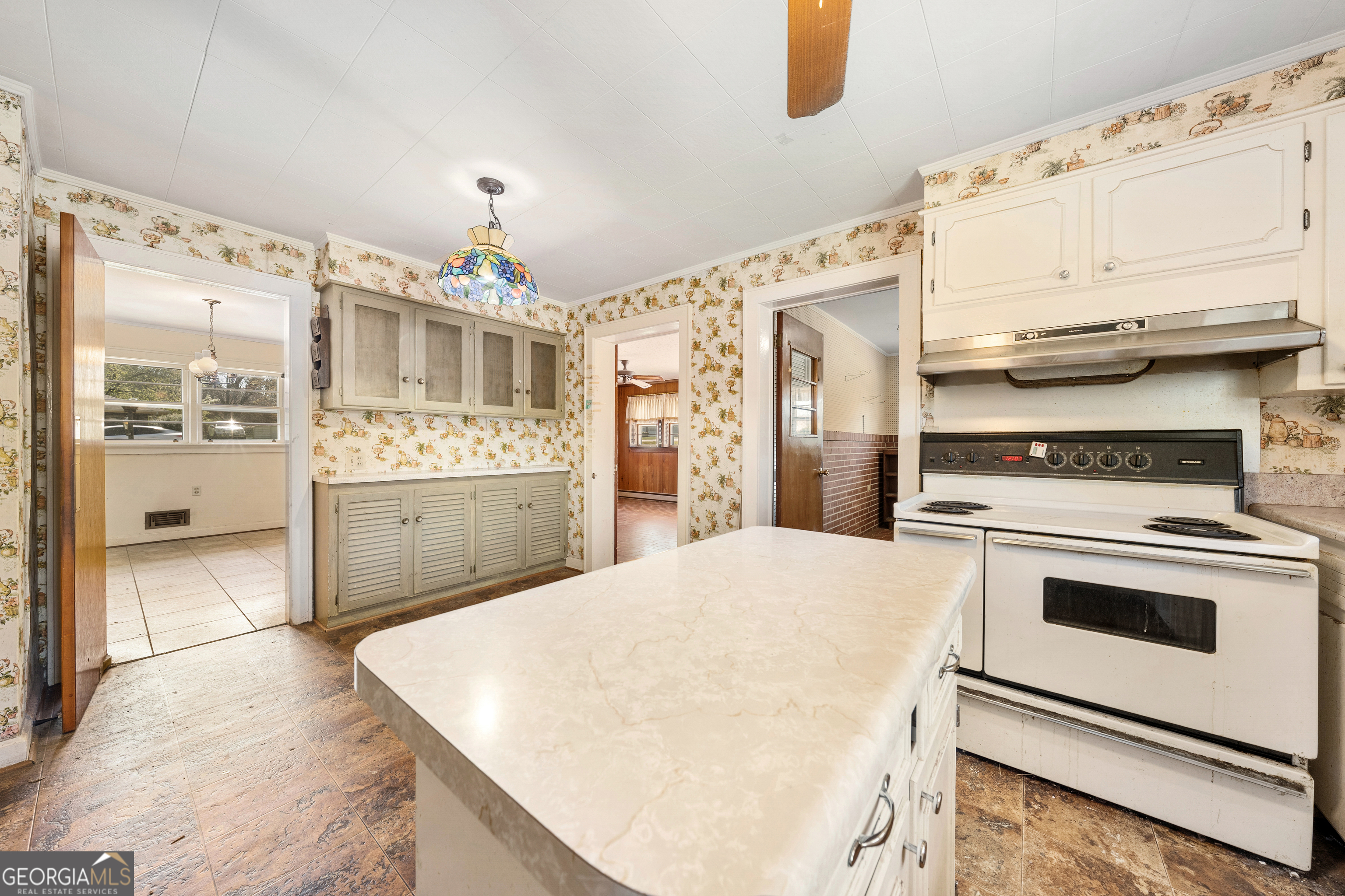 868 Fairview Street Hartwell, GA 30643 - Photo 12 of 42 a kitchen with stainless steel appliances a white stove top oven cabinets a chimney and a window