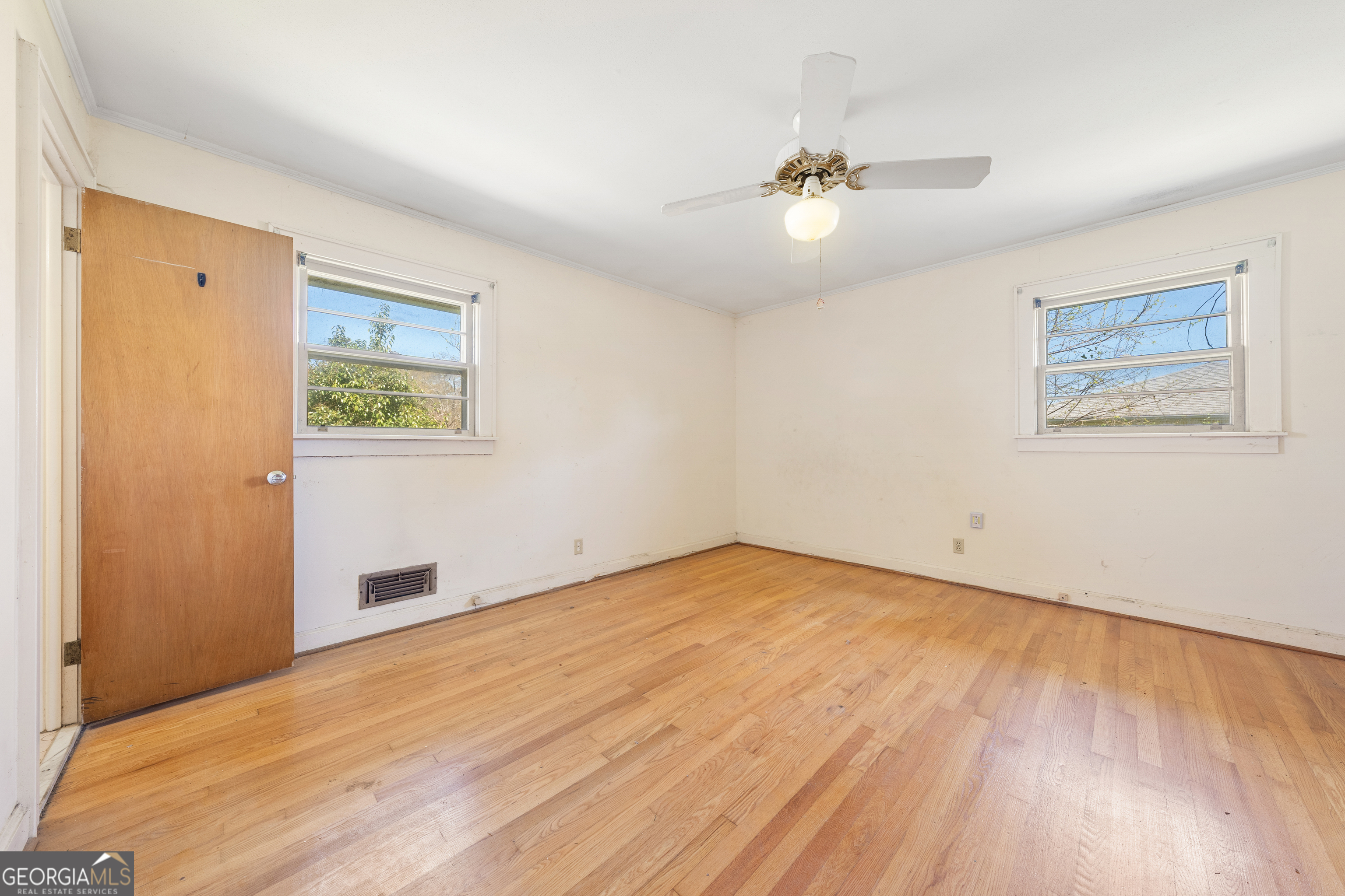 868 Fairview Street Hartwell, GA 30643 - Photo 13 of 42 a view of a room with wooden floor and a ceiling fan