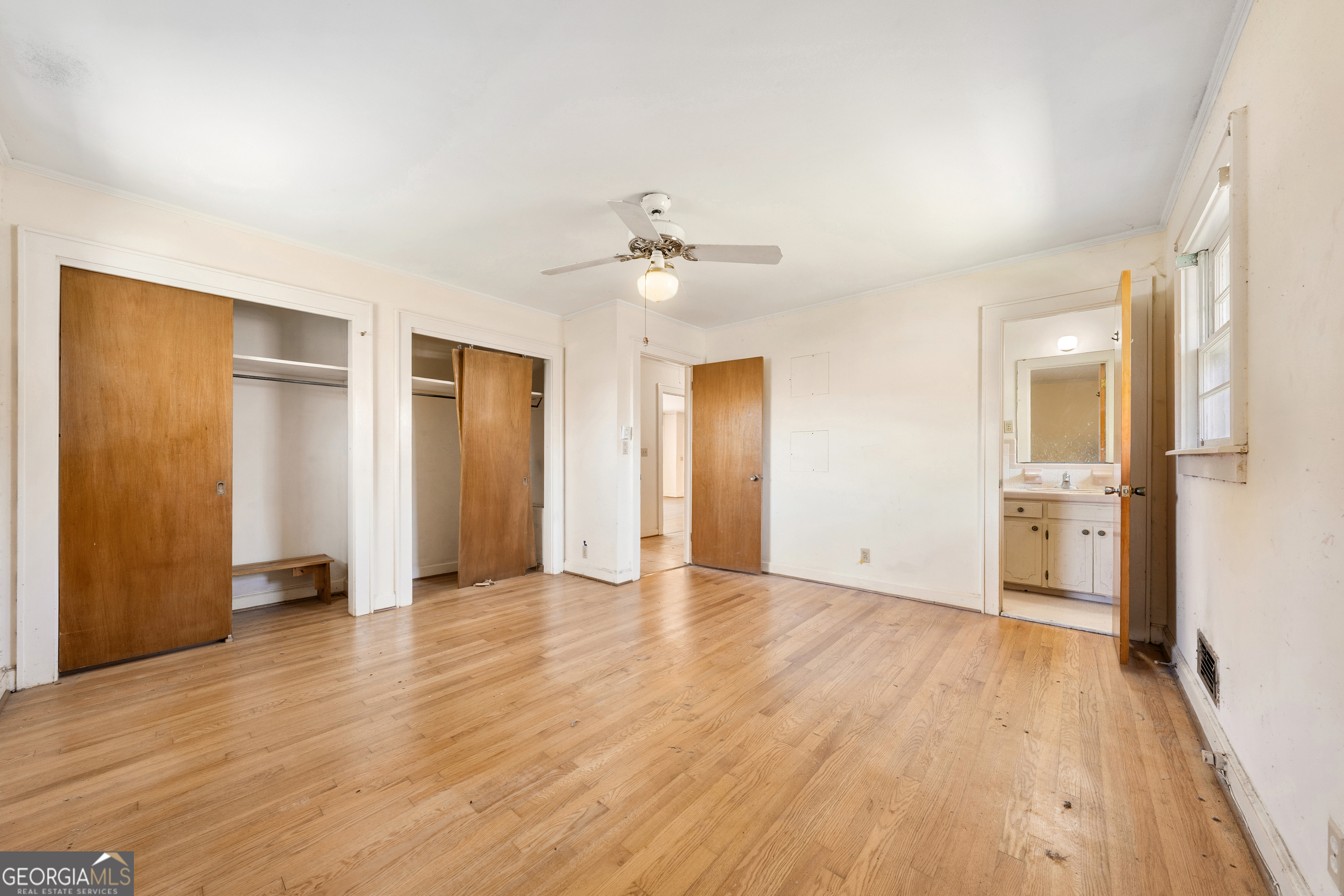 868 Fairview Street Hartwell, GA 30643 - Photo 14 of 42 a view of an empty room with wooden floor and a kitchen