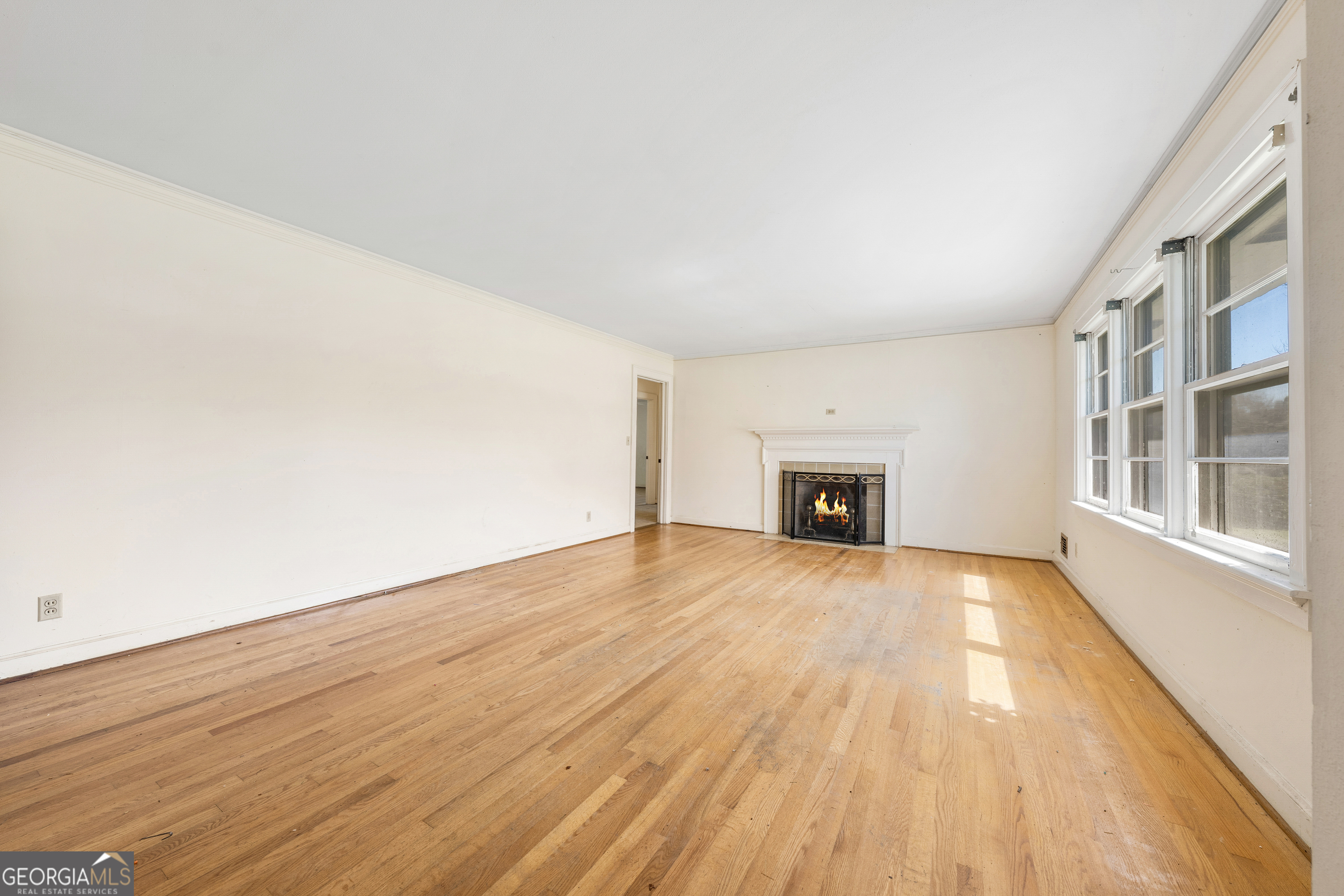 868 Fairview Street Hartwell, GA 30643 - Photo 7 of 42 a view of an empty room with wooden floor and a window