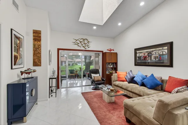 a kitchen with stainless steel appliances kitchen island granite countertop a refrigerator and a sink