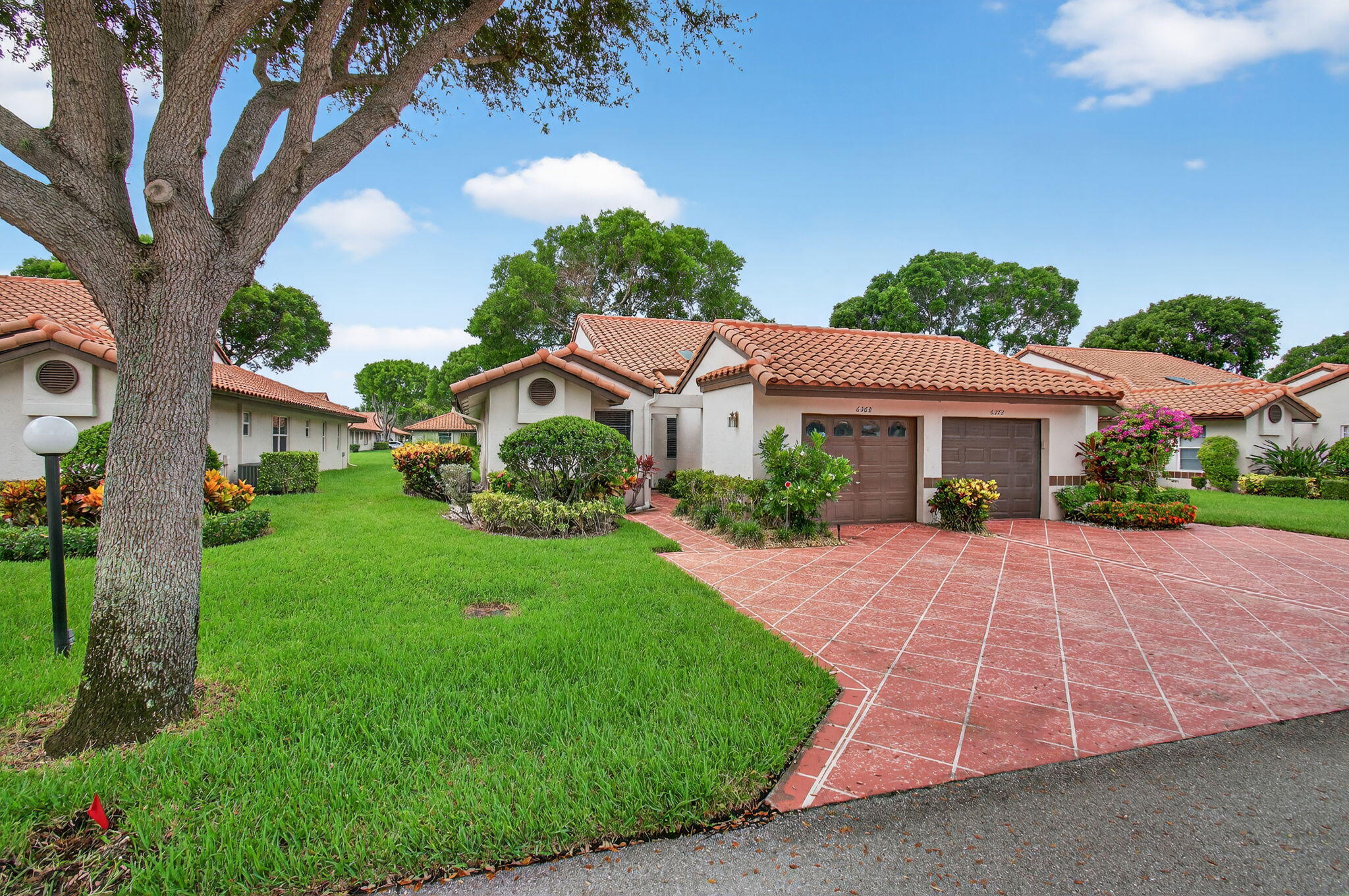 6368 Mill Pointe Circle Delray Beach, FL 33484 - Photo 2 of 132 a front view of a house with a yard and garage