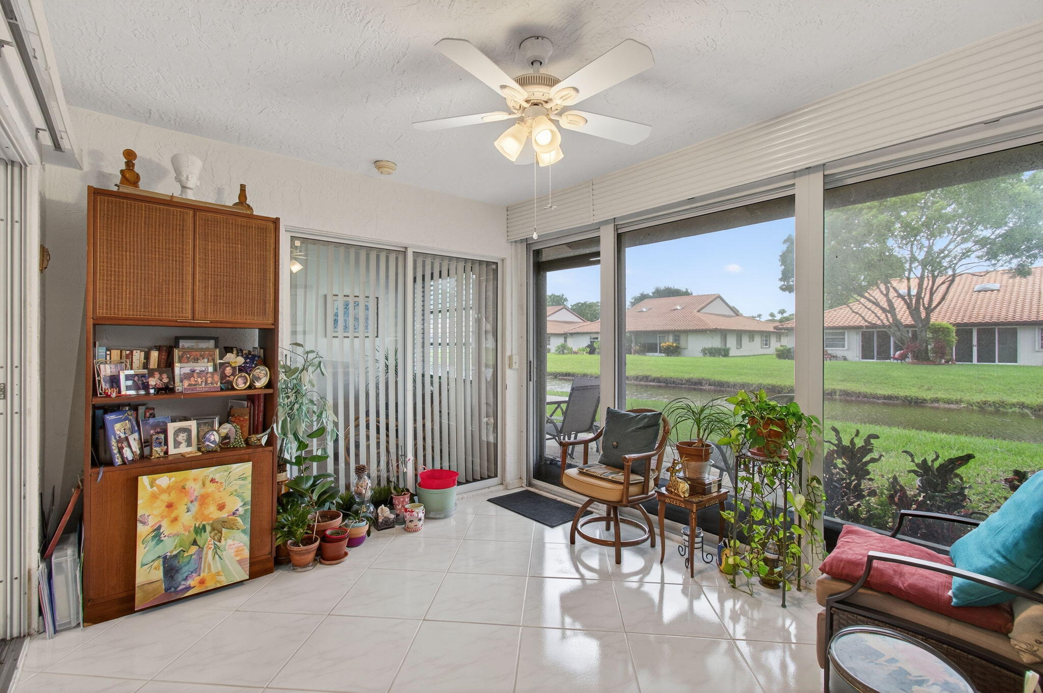 6368 Mill Pointe Circle Delray Beach, FL 33484 - Photo 21 of 132 a living room with furniture a floor to ceiling window and a flat screen tv