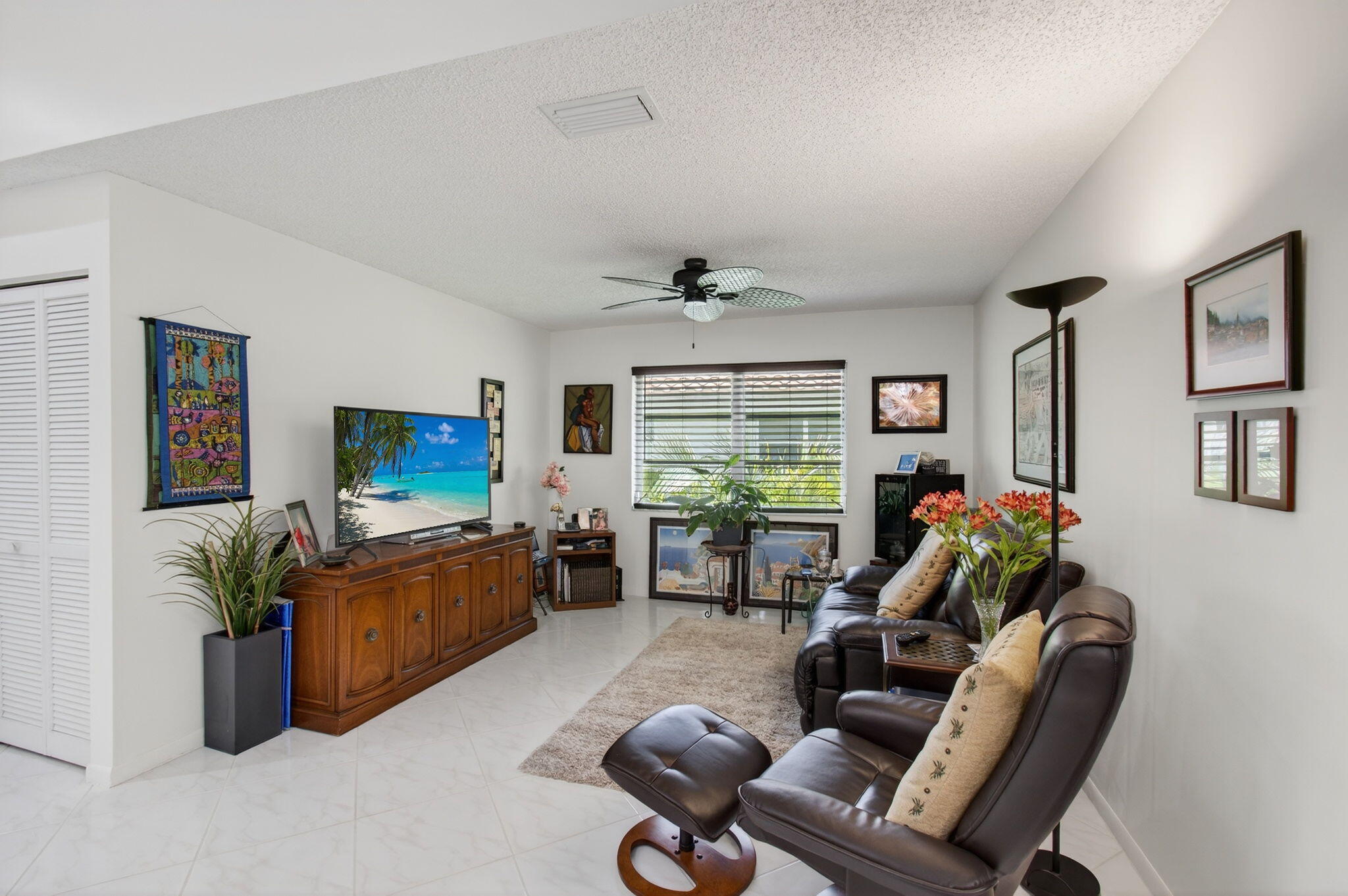 6368 Mill Pointe Circle Delray Beach, FL 33484 - Photo 25 of 132 a living room with furniture or couch and a flat screen tv