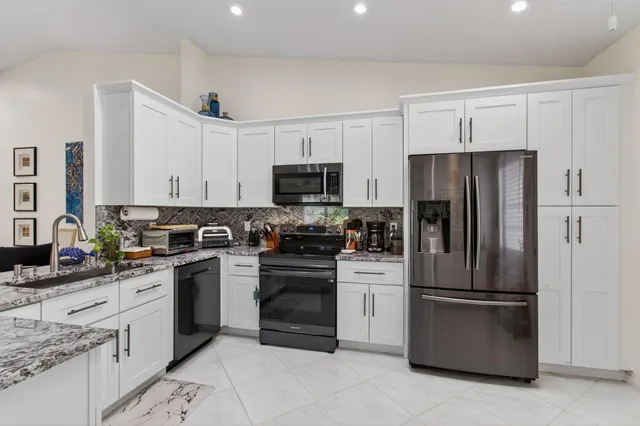 an aerial view of a house with a garden and lake view