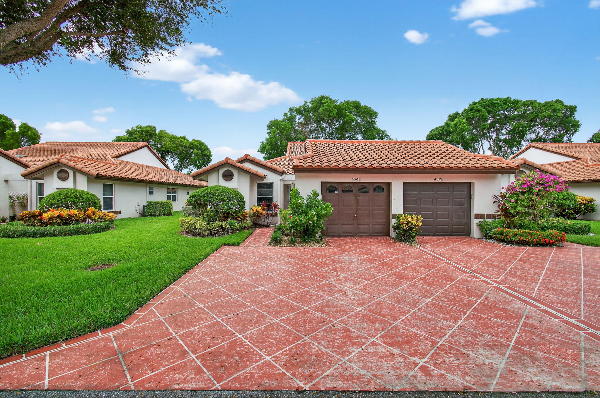 6368 Mill Pointe Circle Delray Beach, FL 33484 - Photo 4 of 132 a front view of a house with a yard and garage
