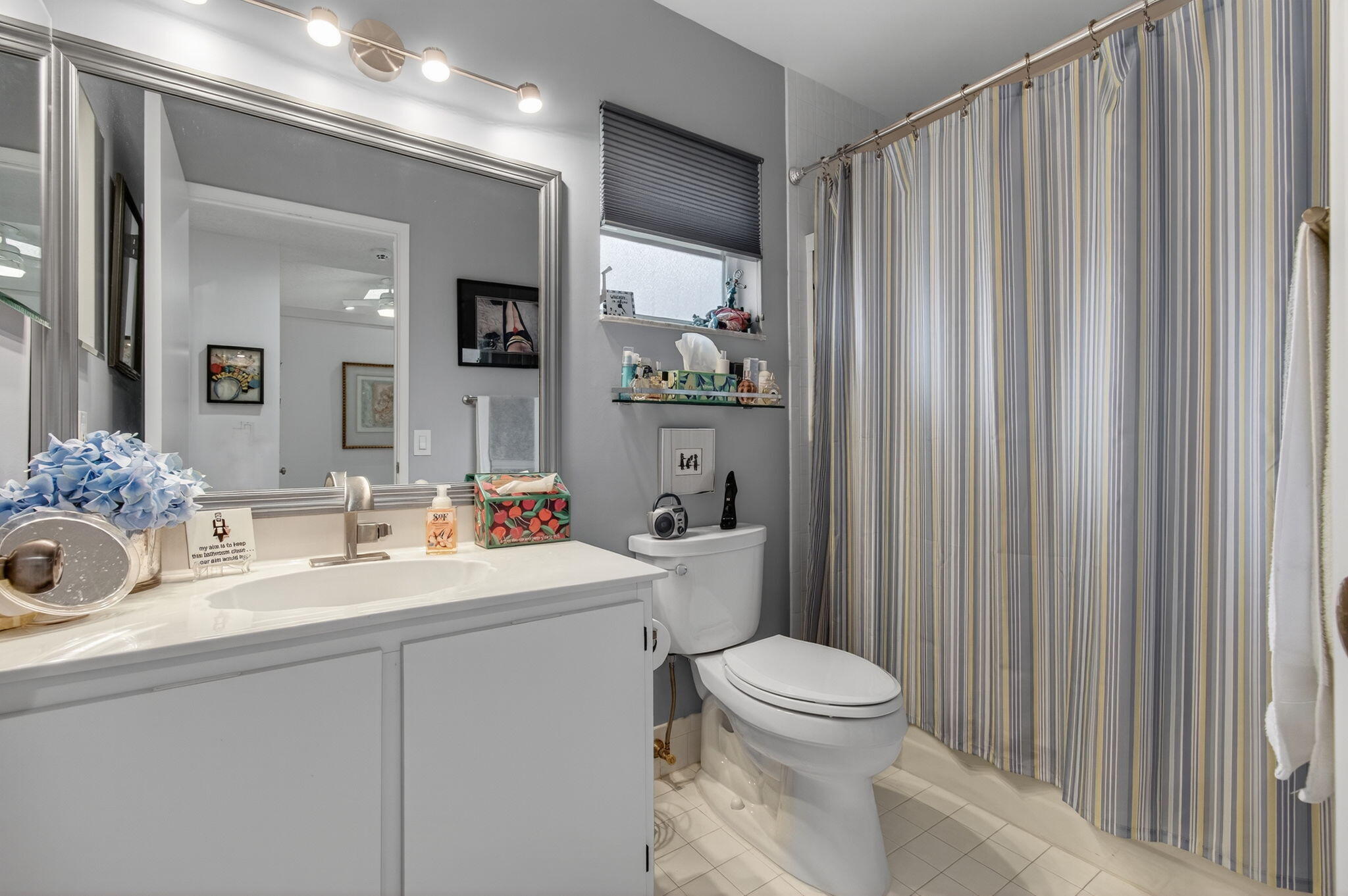 6368 Mill Pointe Circle Delray Beach, FL 33484 - Photo 47 of 132 a bathroom with a sink a toilet and mirror