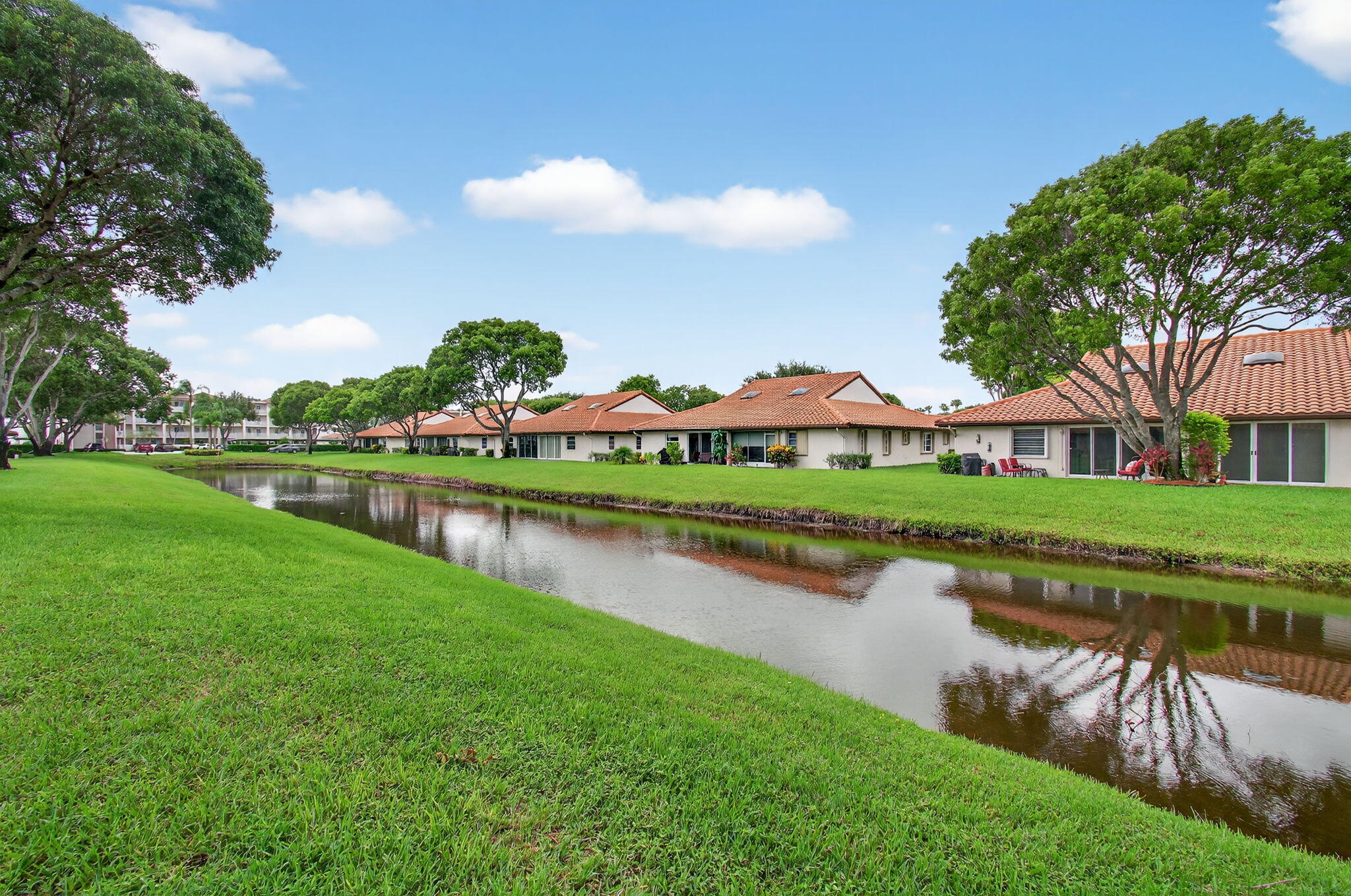 6368 Mill Pointe Circle Delray Beach, FL 33484 - Photo 60 of 132 a view of a house with a garden and lake view