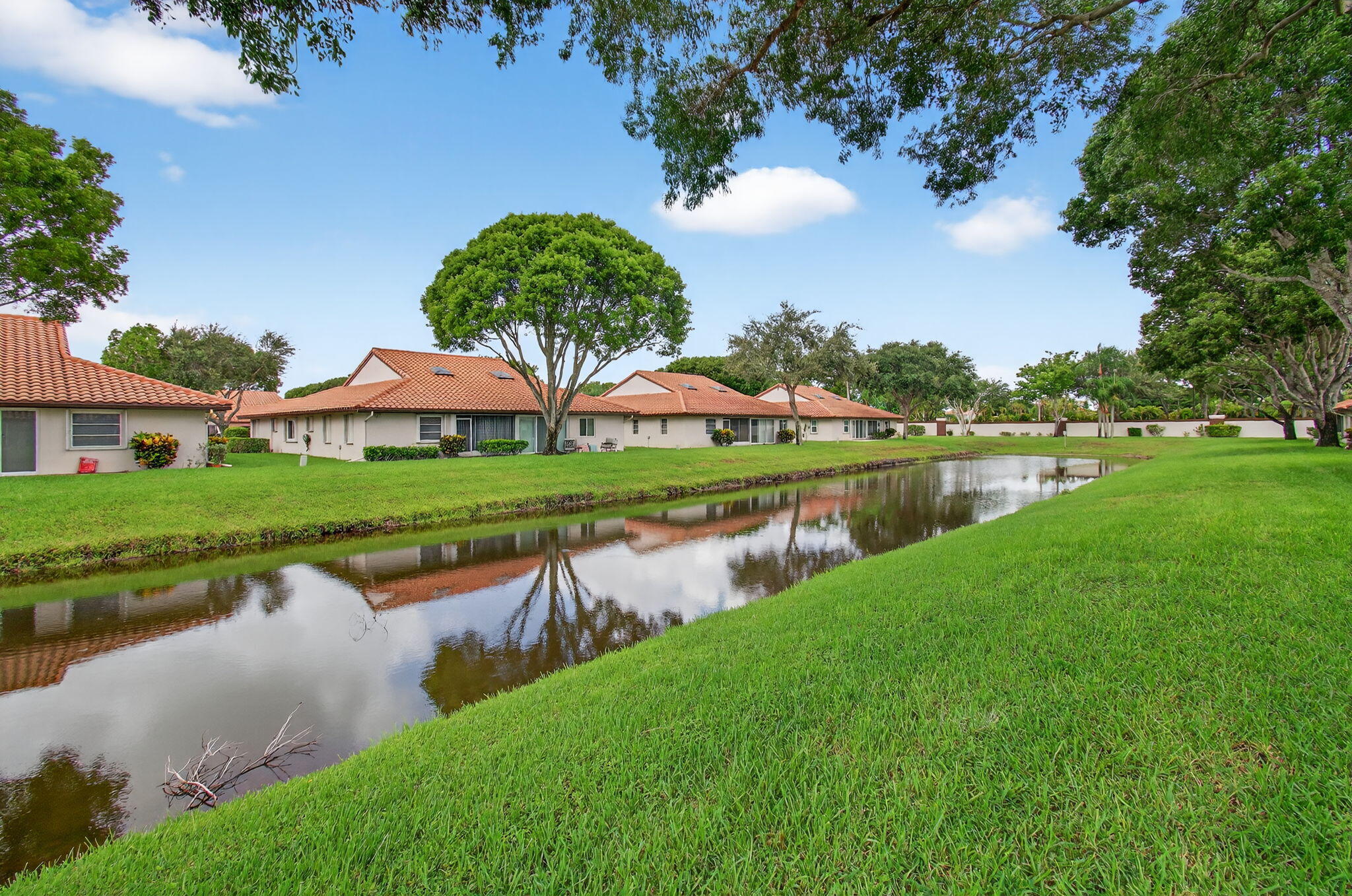 6368 Mill Pointe Circle Delray Beach, FL 33484 - Photo 61 of 132 a view of a lake with houses in the back