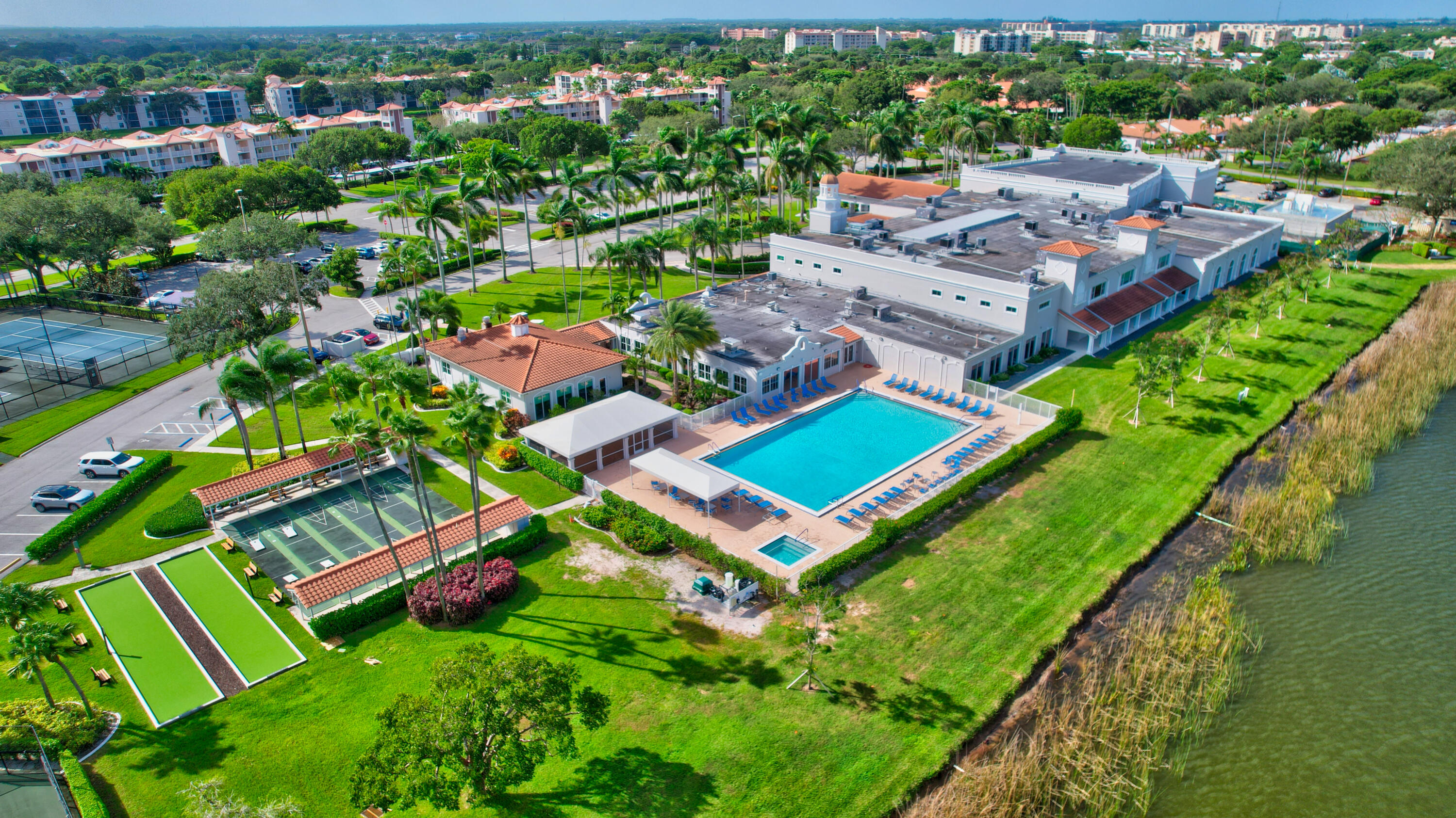 6368 Mill Pointe Circle Delray Beach, FL 33484 - Photo 62 of 132 an aerial view of a house with a garden and swimming pool