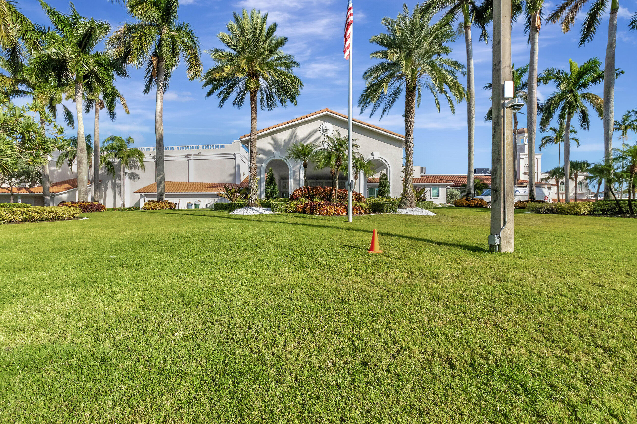 6368 Mill Pointe Circle Delray Beach, FL 33484 - Photo 81 of 132 a view of a palm trees in front of a building