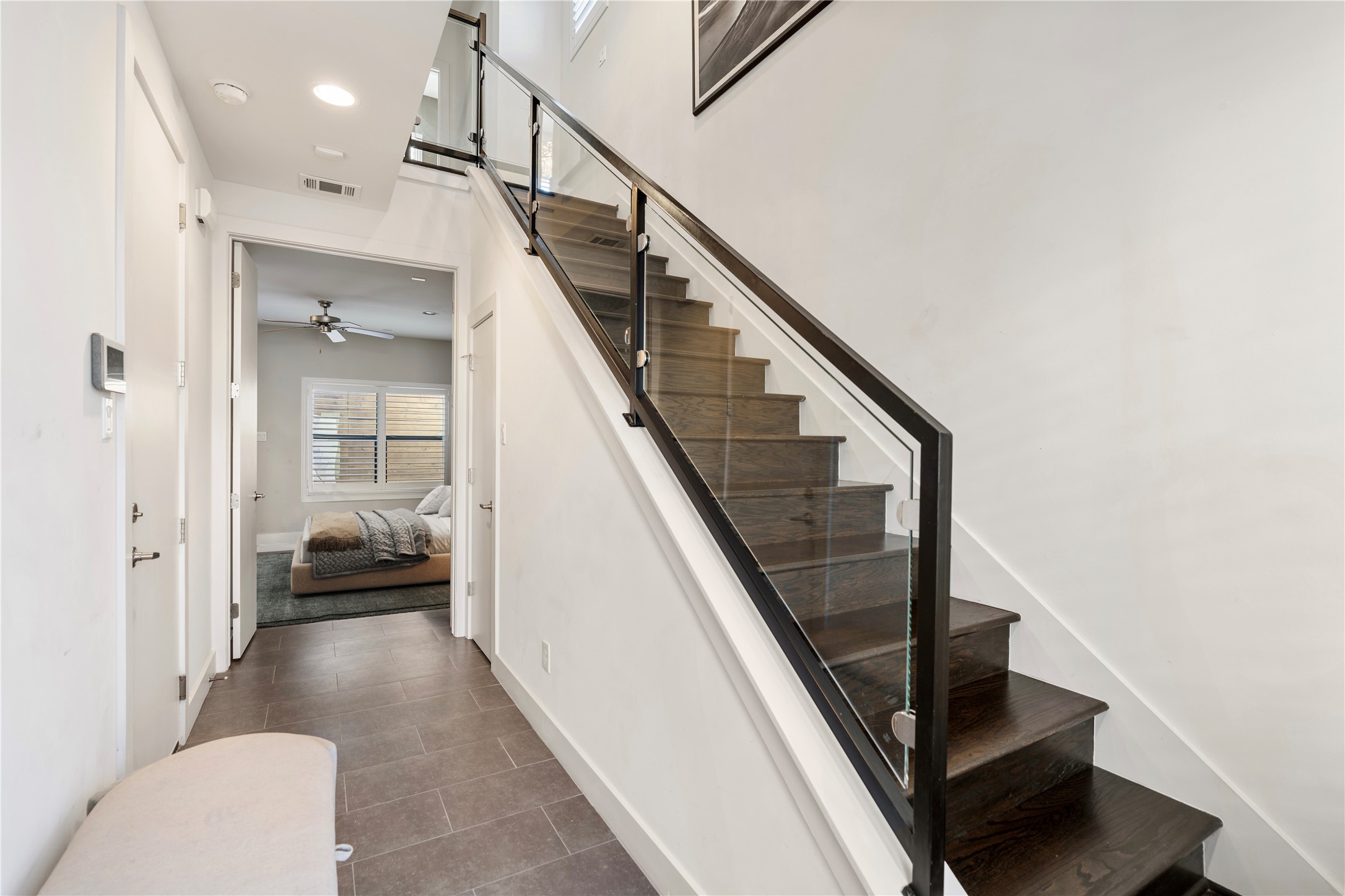 5911 Rose Street Houston, TX 77007 - Photo 6 of 40 Welcoming first-floor entry with soaring ceilings, modern staircase, and abundant natural light creating an immediate sense of openness.