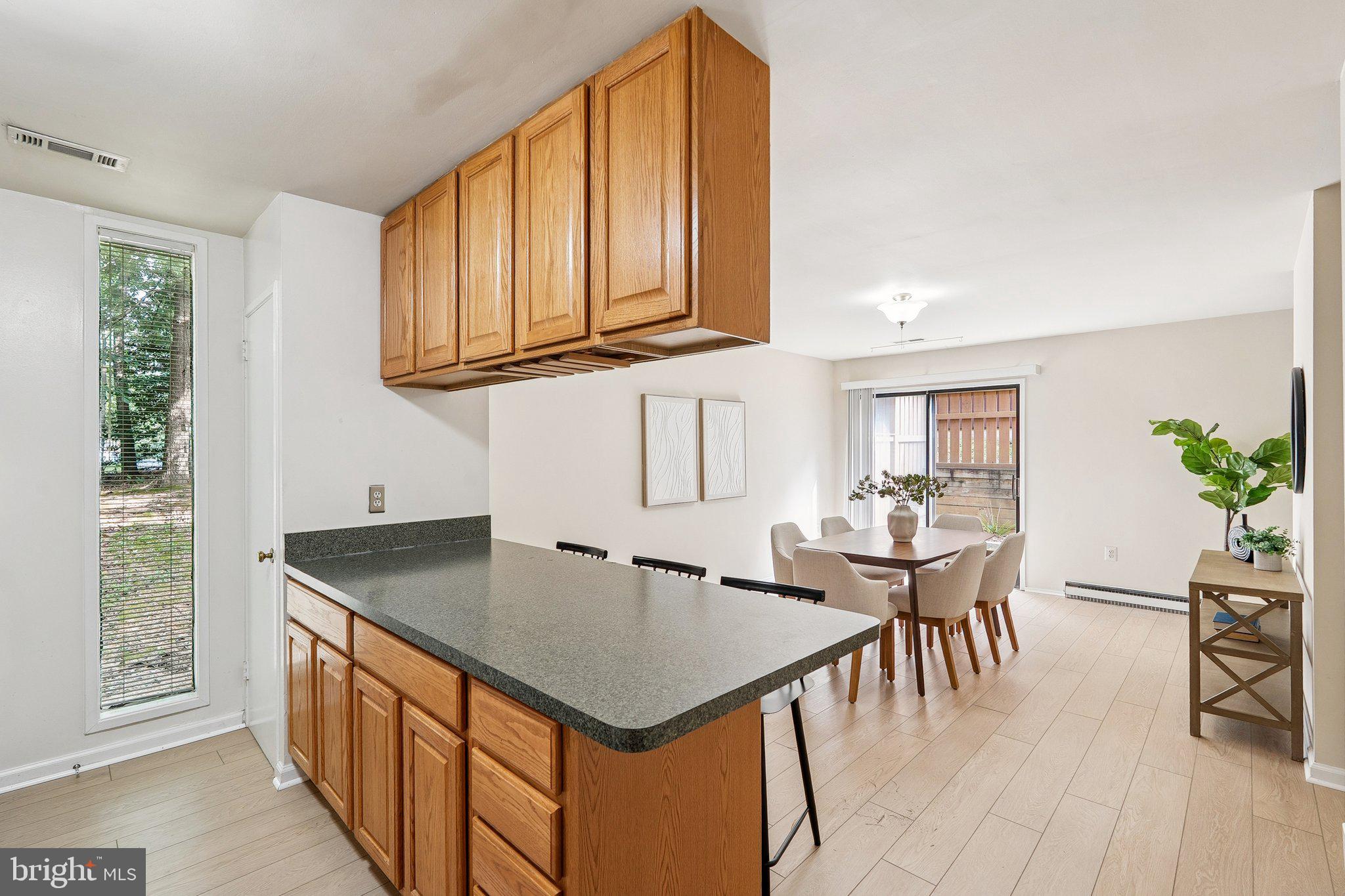 2343 Glade Bank Way Reston, VA 20191 - Photo 12 of 38 a kitchen with stainless steel appliances granite countertop a sink a microwave cabinets and wooden floor