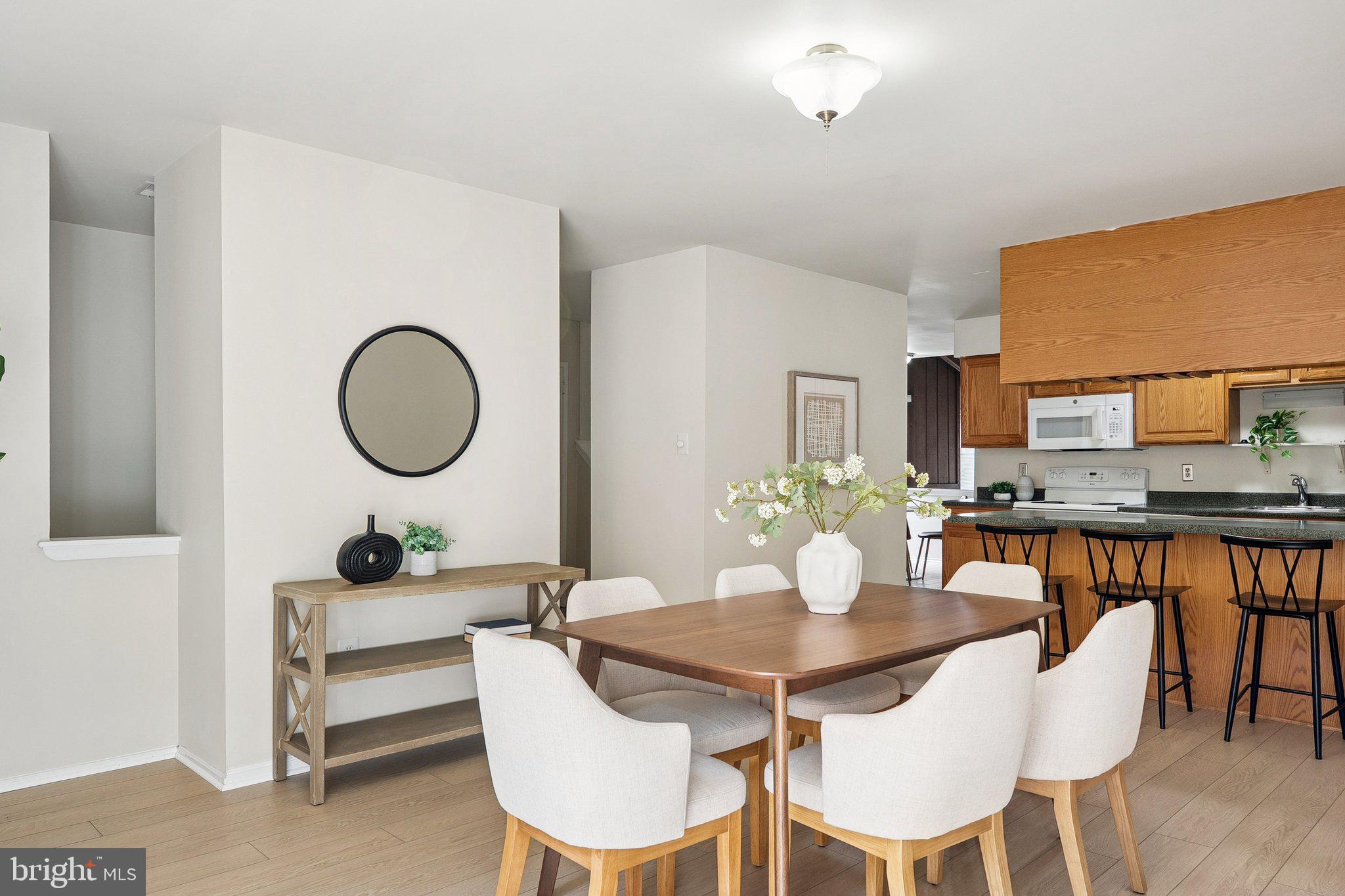 2343 Glade Bank Way Reston, VA 20191 - Photo 15 of 38 a view of a dining room with furniture and wooden floor