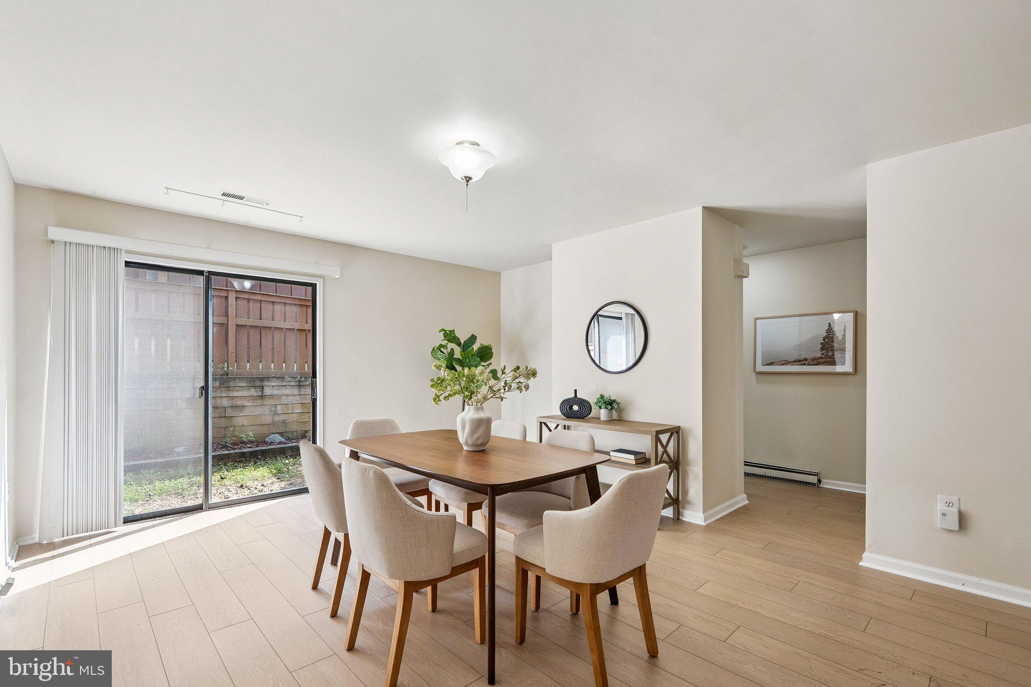 2343 Glade Bank Way Reston, VA 20191 - Photo 16 of 38 a view of a dining room with furniture and wooden floor