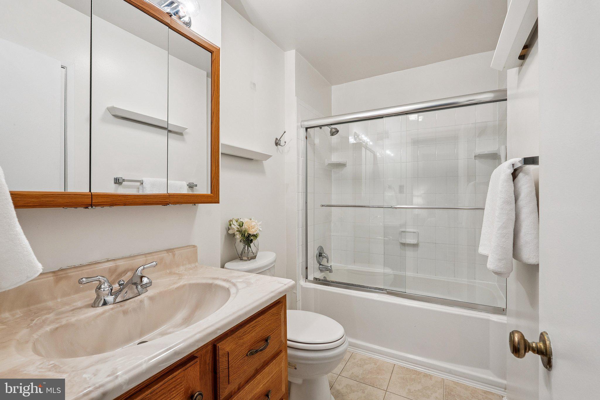 2343 Glade Bank Way Reston, VA 20191 - Photo 22 of 38 a bathroom with a granite countertop sink toilet and shower